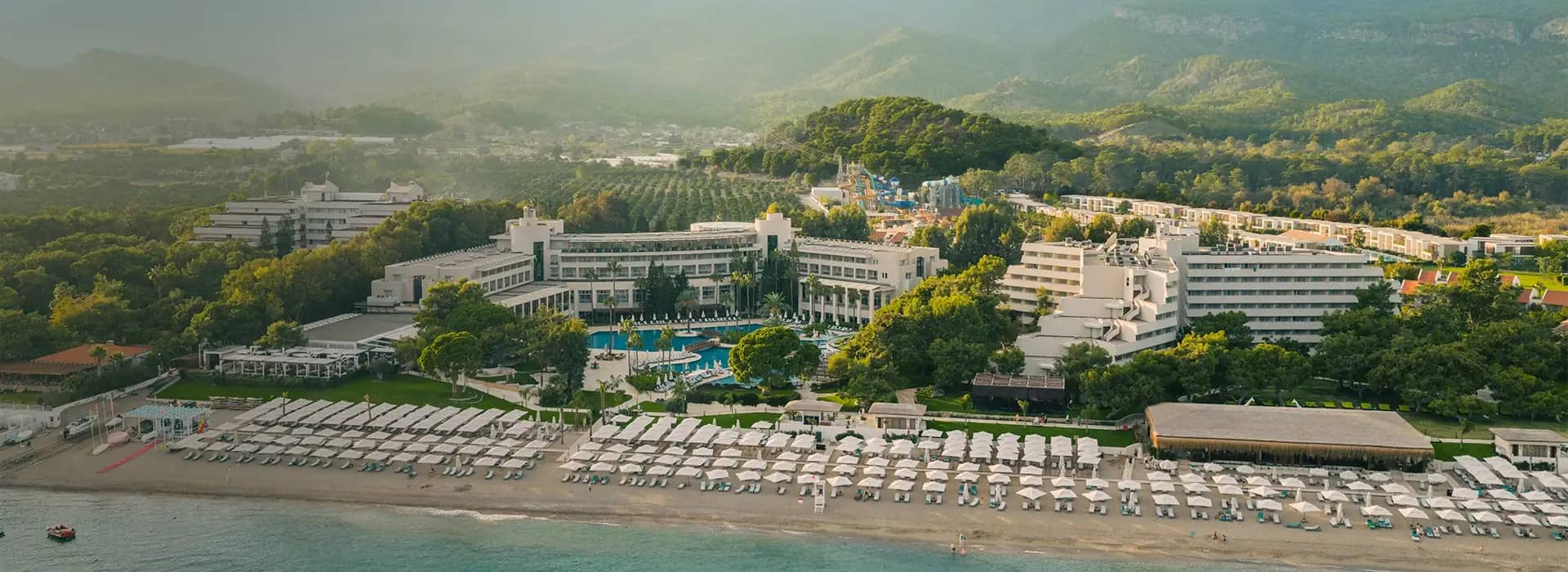 <div style="padding-left: 70px;"><img style="width: 100px; height: auto; margin: 25px 0;" src="https://b2ccdn.coraltravel.ee/content/Main Page Hotels Banners Destinations_Turkyie EE.svg"></div>
<div style="padding-left: 70px; margin-bottom: 20px;"><img style="width: 200px; height: auto;" src="https://b2ccdn.coraltravel.lt/content/logos/hotel-logos/rixos-logo-white-200-55.webp" loading="lazy"></div>
<div style="font-size: 0.8em; font-weight: 600; padding-left: 70px;">Rixos Premium Tekirova</div>